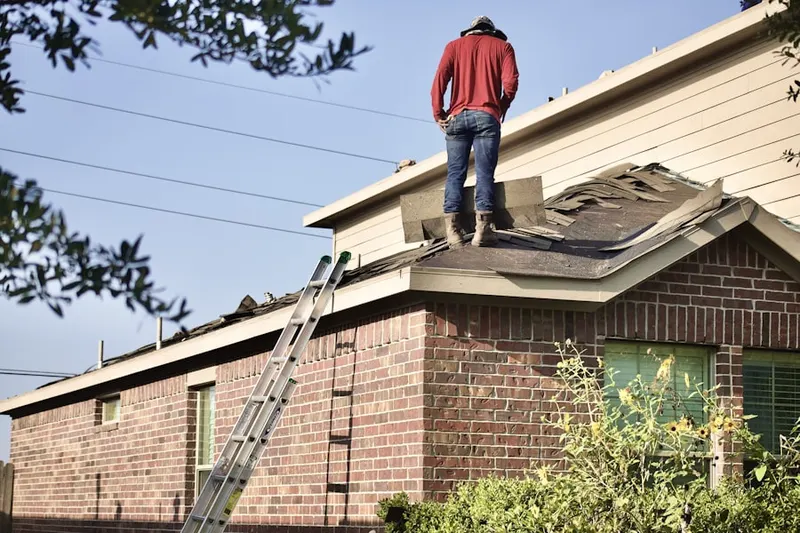 Professional roofer working on a residential roof in King-Lincoln Bronzeville